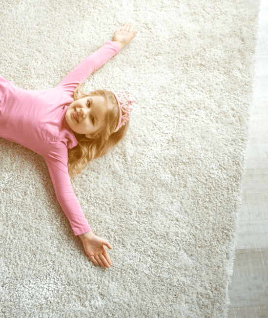 Cute girl laying on rug | Montgomery's CarpetsPlus COLORTILE
